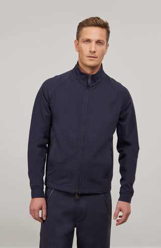 Sportliche Herrenjacke James Felpa aus hochwertiger italienischer Baumwolle mit elastischem, formstabilem Material und weichem Griff. Die gerade, körperbetonte Passform, der Stehkragen und der markante Zwei-Wege-Zipper verleihen der Jacke einen modernen, sportiven Look. Mit seitlichen Schlüpftaschen für praktische Funktionalität. Dank Elasthan-Anteil bietet sie optimale Bewegungsfreiheit und bleibt dennoch in Form – ideal für Homewear, entspannte Spaziergänge und leichte sportliche Aktivitäten.