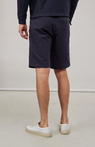 Herren-Bermuda Flynn Bermuda in midnight aus hochwertigem Baumwollmix mit Natural Powerstretch. Besonders weich und angenehm auf der Haut, mit weitem Bein für lockeren Sitz und elastischem Bund für optimalen Komfort. Zwei seitliche Eingrifftaschen mit Alcantara-Besatz sowie eine Gesäßtasche mit Reißverschluss. Vielseitig und bequem für Alltag und Freizeit.