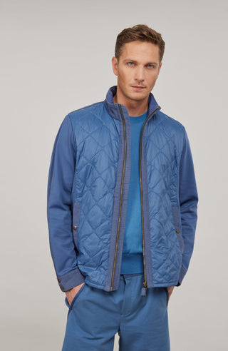 Maskuline Herrenjacke in moderner Quilt-Optik mit sportiv-lässiger Silhouette. Der exklusive Materialmix aus Natural Powerstretch und Leinen verbindet Leichtigkeit, Komfort und eine markante Struktur. Feine Leinen-Details an Kragen, Schultern und Ärmelabschlüssen sowie dezente Alcantara-Akzente verleihen der Jacke ihre charaktervolle Wertigkeit. Mit kleinem Stehkragen, Reißverschluss und zwei Taschen mit Metall-Druckknöpfen. Vielseitig kombinierbar – für urbane und sportive Looks mit modernem Anspruch.
