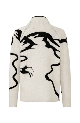 Rueckansicht eines Damenpullovers aus 100 % extrafeiner Merinowolle, Modell „Chatel-ME“ in der Farbe Weiss. Die Vorderseite zeigt ein kunstvoll gestaltetes Jacquard-Motiv aus skizzierten Berglandschaften, urbanen Elementen und dynamischen Skifahrern. Das hochwertige Merinogarn – leicht, weich und angenehm auf der Haut – wird in Italien produziert und auf modernsten Maschinen verarbeitet. Die Kombination aus künstlerischem Design & technischer Strickkunst macht den Pullover besonders stilvoll