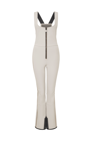 Ski-Catsuit Davina2.0-S im Latzhosen-Stil ohne Ärmel, schmaler figurbetonter Schnitt mit ausgestelltem Bein, femininer Bustier-Ausschnitt, Streifen an den Beinaußenseiten aus Alcantara-Leder, Träger hinten aus elastischem Gummi, ergonomisches Knie, markanter langer Zipper, auffallende Nähte, Seitentaschen mit Zip, Kantenschutz aus Alcantara-Leder und Schneefang. Enganliegend, feminin, betont Silhouette und Bewegungsfreiheit. In der Farbe Weiß-Beige (Farbe: sandstone)